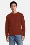 Rouge textured crewneck sweatshirt by Petrol Ind, featuring ribbed cuffs and hem, with small chest patch logo, front view on model wearing blue jeans