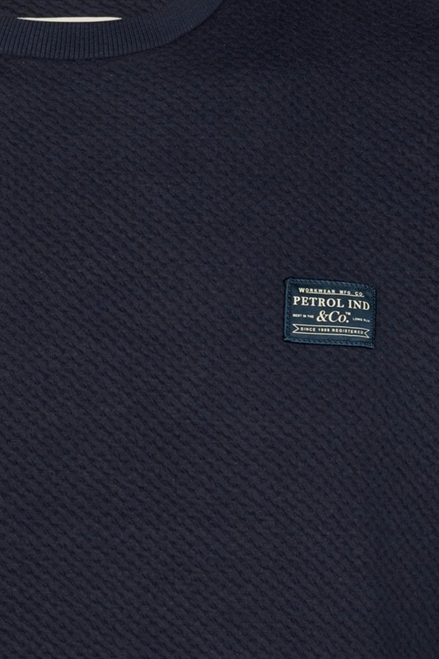 Navy blue ribbed crewneck sweatshirt by Petrol Ind & Co. with textured weave and branded patch on chest, close-up view