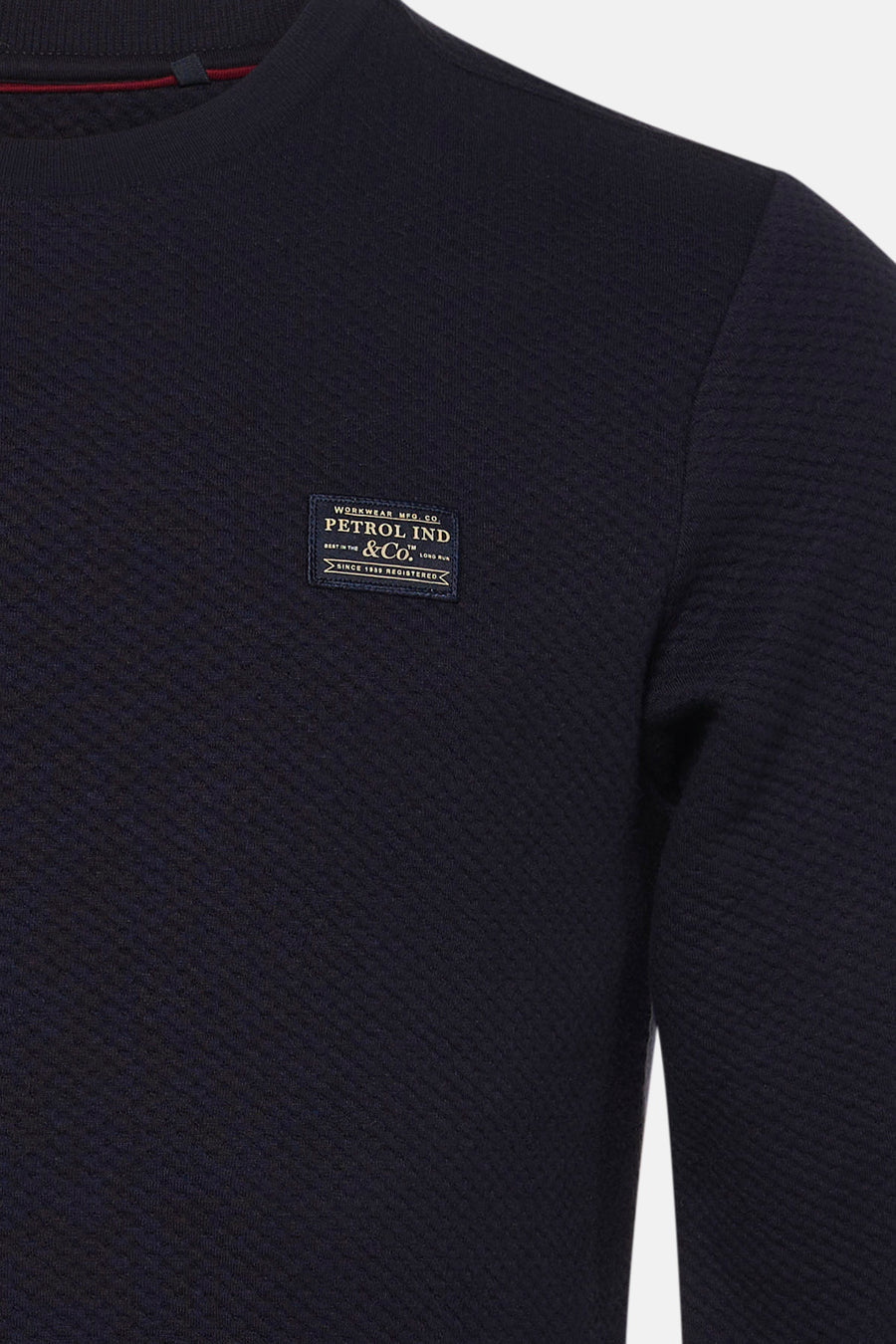 Navy blue textured crewneck sweatshirt by Petrol Ind & Co. with ribbed collar and chest patch label, close-up front view