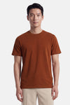 Orange short-sleeve t-shirt with round neckline and small chest logo, worn by model in front view