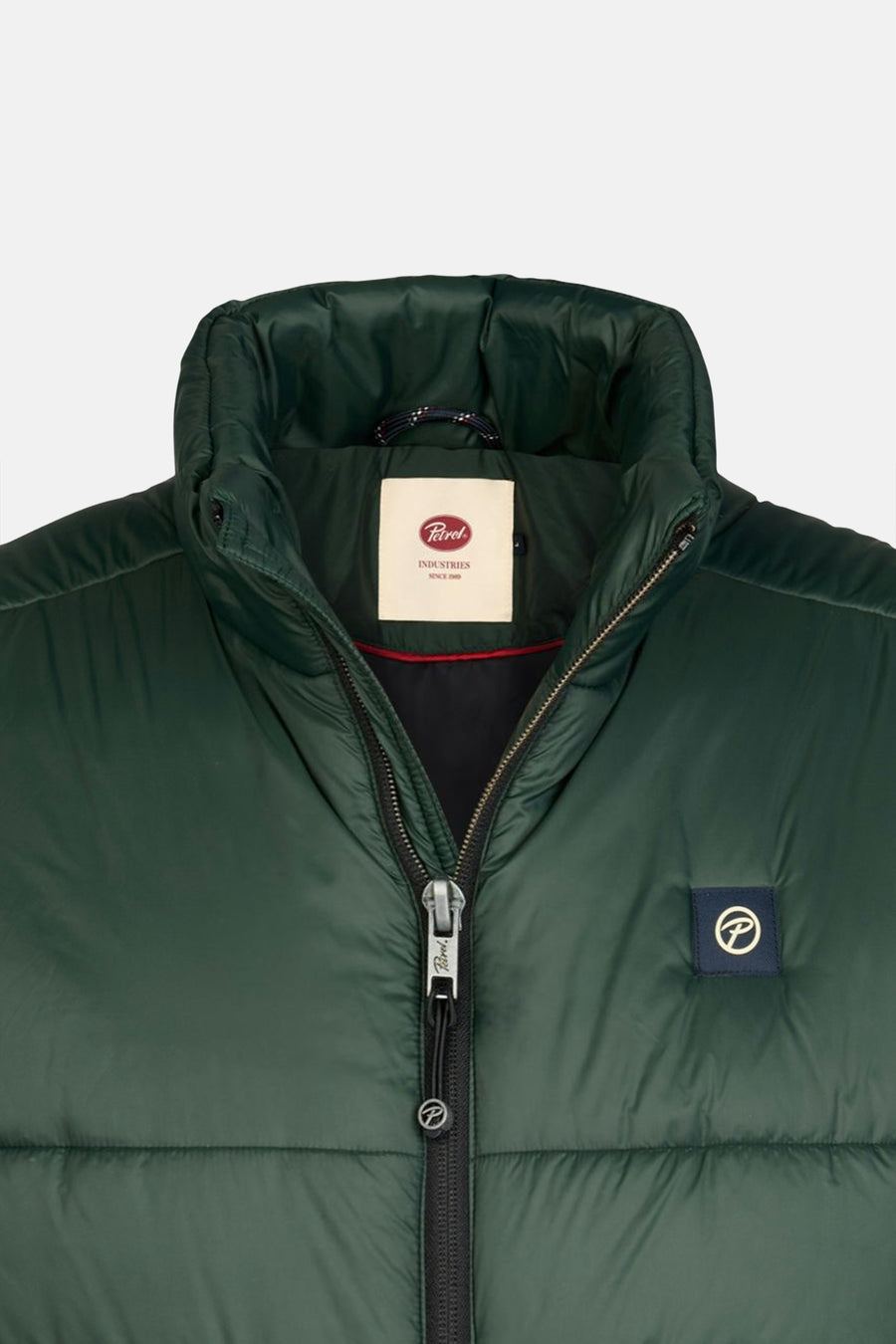 Green quilted sleeveless bodywarmer by Petrol with front zipper and logo patch, close-up view