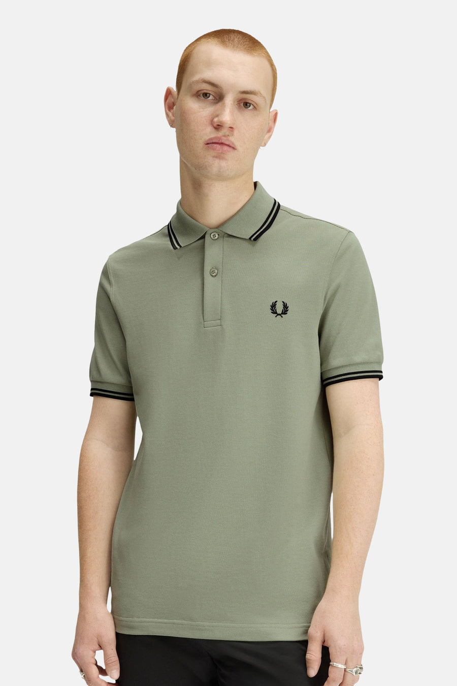 Polo à manches courtes vert de FRED PERRY, bordures noires contrastantes au col et aux manches, logo brodé.