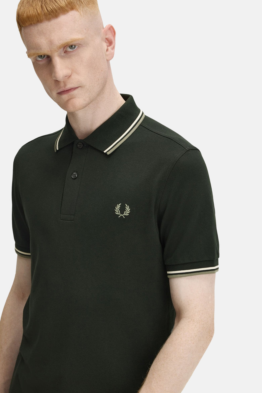 Polo vert à manches courtes de Fred Perry, avec finitions rayées au col et aux manches, et logo brodé.

