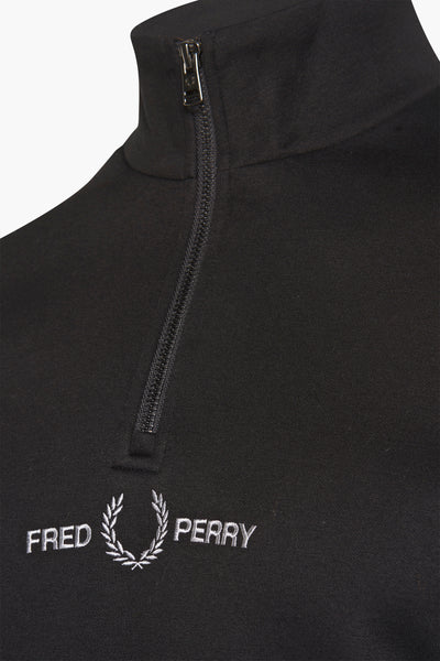 Black high-neck sweatshirt by Fred Perry with silver embroidered logo and front zipper, close-up view