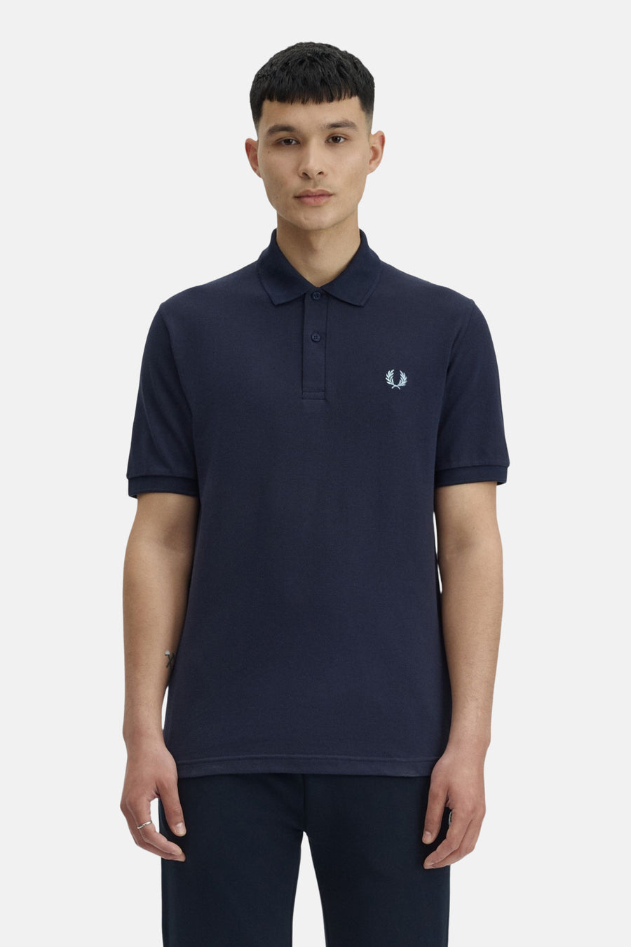 Polo bleu marine de Fred Perry, avec logo brodé sur la poitrine.