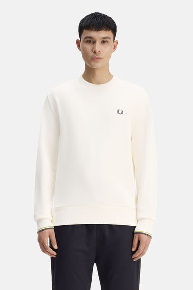 Ecru crewneck sweatshirt by Fred Perry with small embroidered laurel wreath, ribbed cuffs and hem, lime and grey striped trim, front view on model