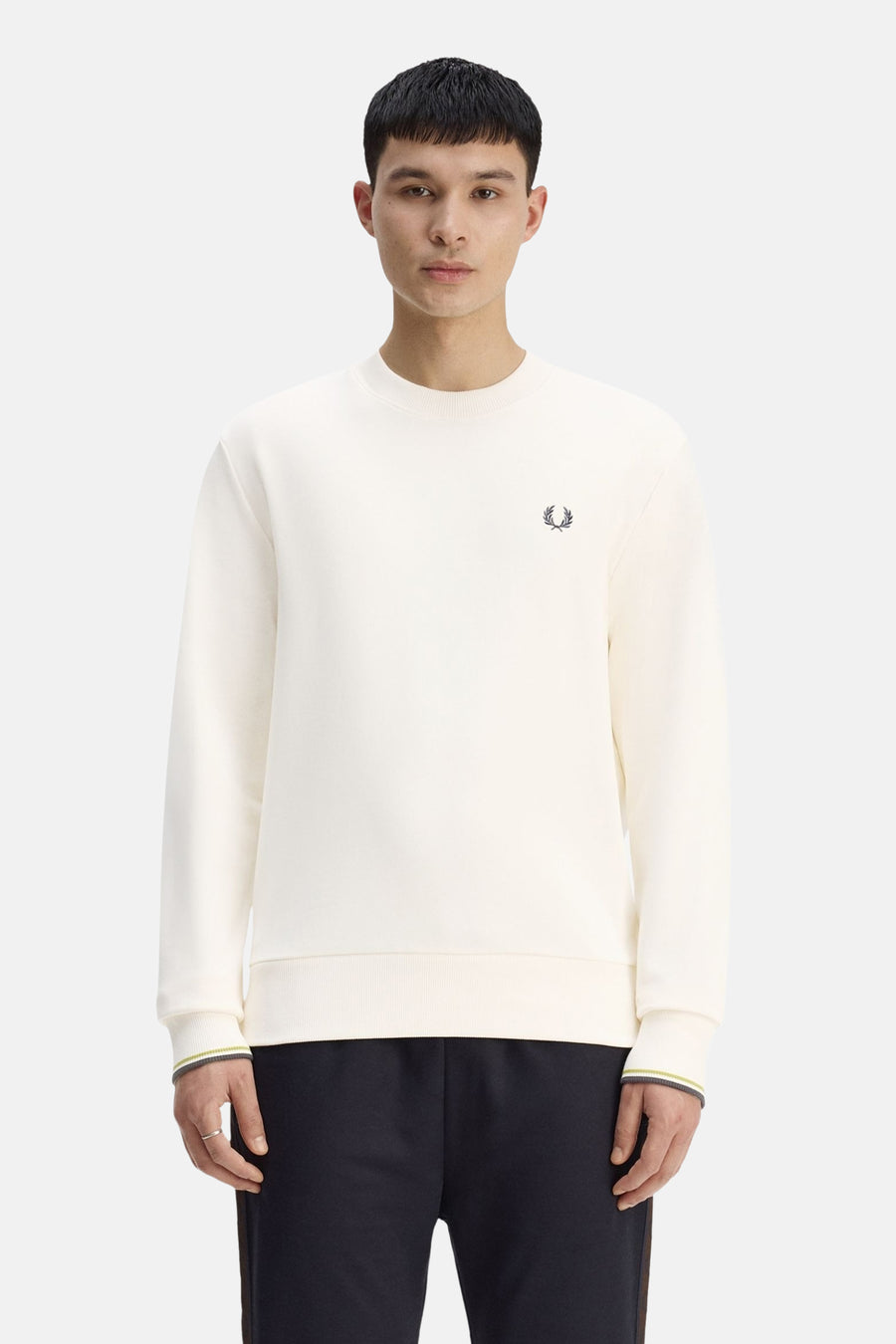 Ecru crewneck sweatshirt by Fred Perry with small embroidered laurel wreath, ribbed cuffs and hem, lime and grey striped trim, front view on model