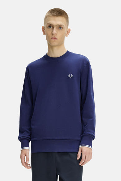 Blauwe rondehals sweatshirt van FRED PERRY met geborduurd logo, witte gestreepte manchetten en geribbelde zoom.