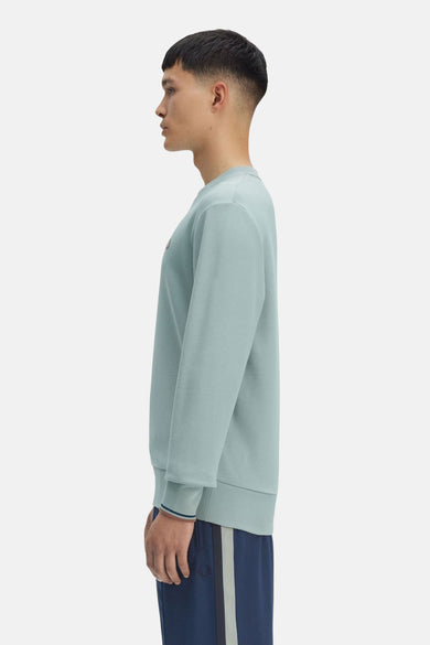 Sweat bleu de FRED PERRY, coupe classique avec poignets côtelés à rayures contrastantes.