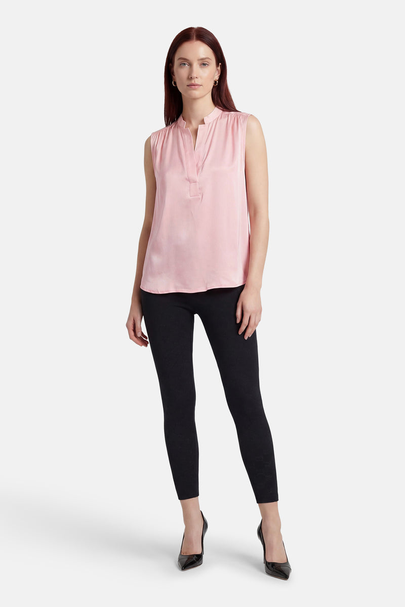 Roze mouwloos blouse van MEXX, gedragen met een zwarte broek en zwarte lakpumps.