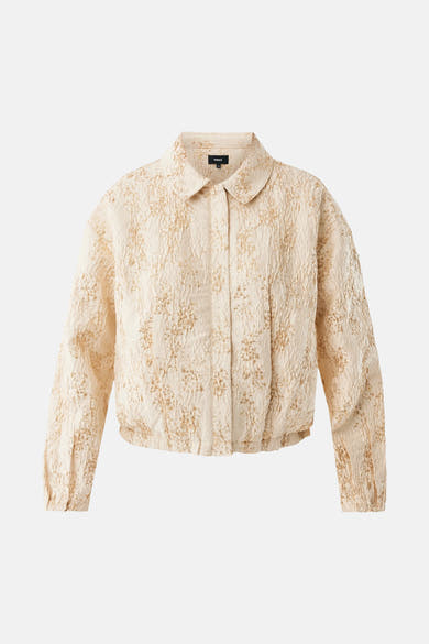 Veste courte beige de MEXX, à texture gaufrée avec subtils motifs dorés, coupe blouson.