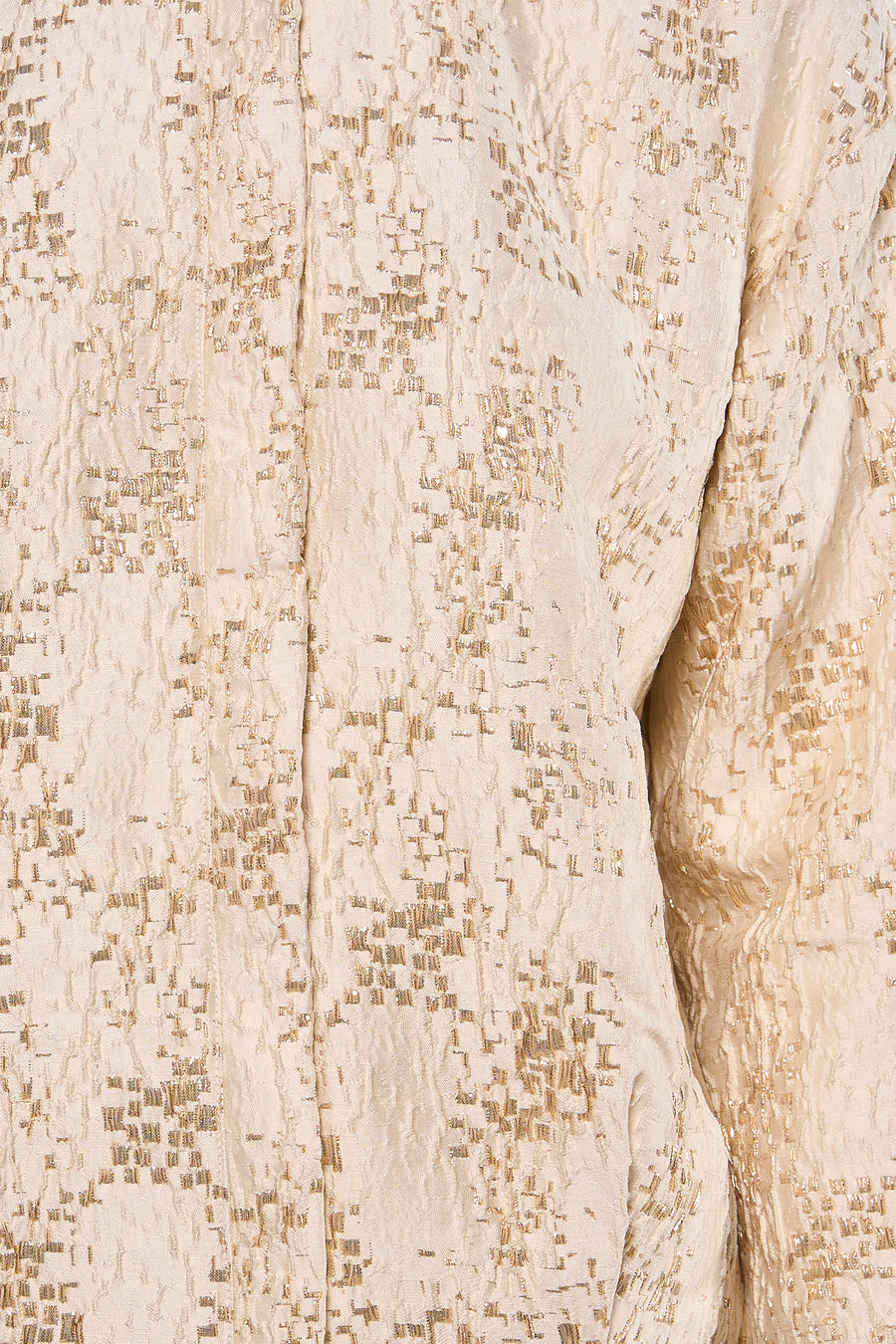 Veste courte beige de MEXX avec motifs carrés dorés et texture froissée.