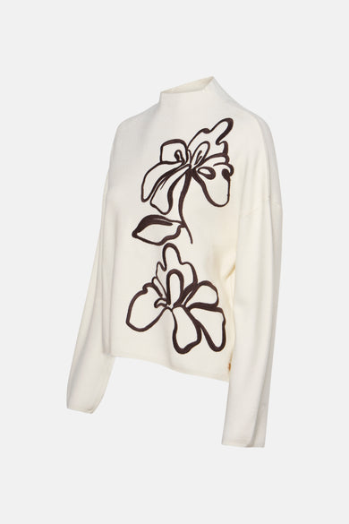 Pull à col roulé écru de MEXX avec motif floral brodé sur le devant.
