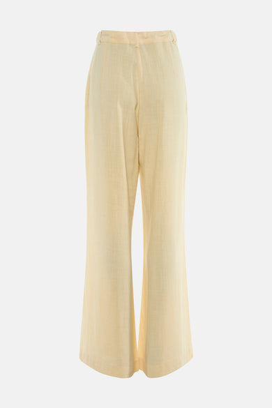 Pantalon jaune de MEXX, coupe ample, matière texturée, vue arrière sur fond neutre.