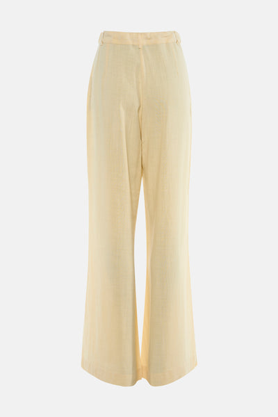 Pantalon jaune de MEXX, coupe ample, matière texturée, vue arrière sur fond neutre.
