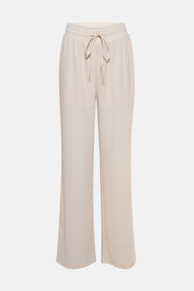 Pantalon écru de MEXX, à texture gaufrée et coupe ample avec cordon de serrage à la taille.
