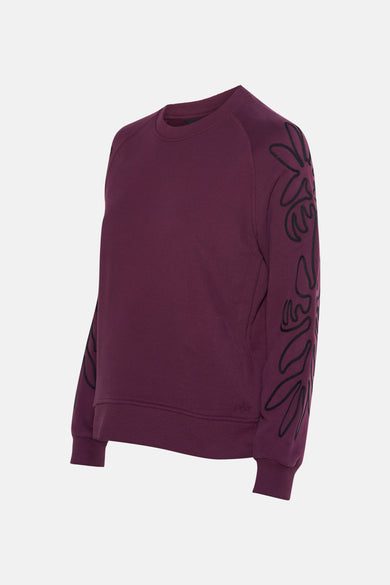 Sweat mauve col rond de MEXX avec broderies florales noires sur les manches.