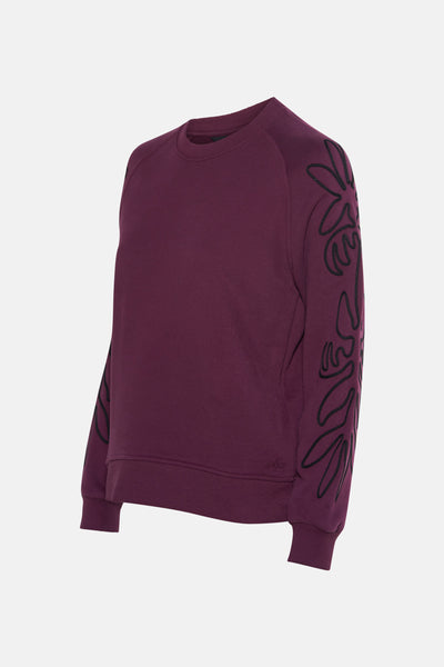 Sweat mauve col rond de MEXX avec broderies florales noires sur les manches.