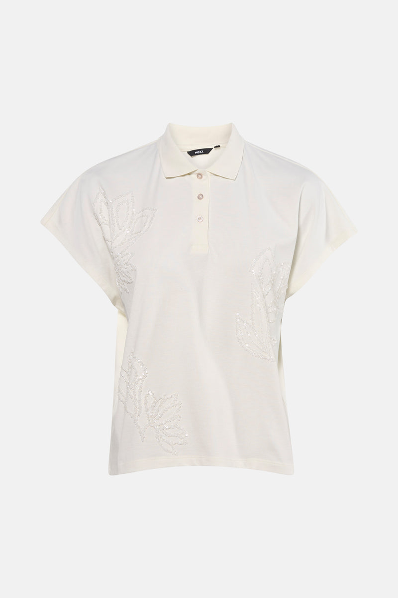 T-shirt blanc de Mexx, avec des motifs floraux brodés de perles ton sur ton.
