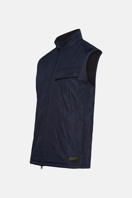 Veste sans manches bleue par Barbour International, motif matelassé losanges et poche poitrine discrète.