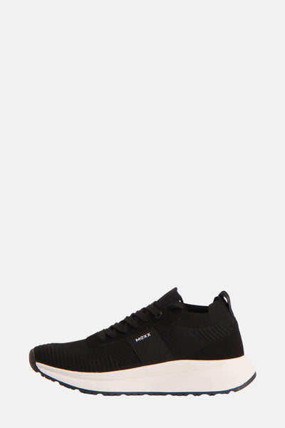 Zwarte MEXX sneakers, met een dikke witte zool en getextureerde details.
