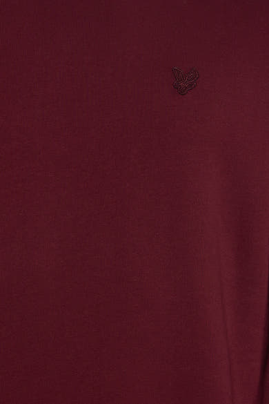 Bordeaux crewneck sweatshirt with subtle butterfly embroidery on chest, close-up view