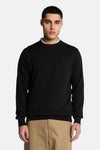 Black crewneck sweatshirt with ribbed cuffs and hem, featuring small embroidered logo on chest, worn by model in front view.