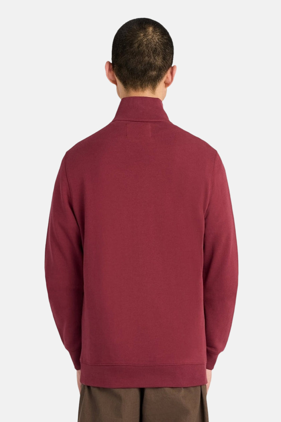 Burgundy high-neck sweatshirt back view, soft textured fabric, ribbed cuffs and hem, model wearing olive pants
