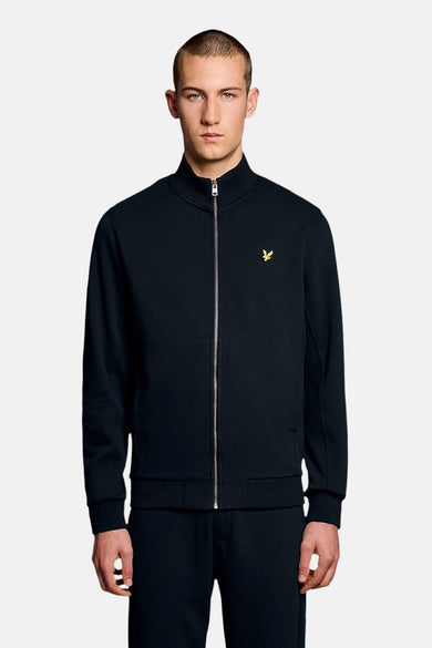 Gilet bleu de LYLE & SCOTT, avec fermeture éclair argentée et logo doré sur la poitrine.