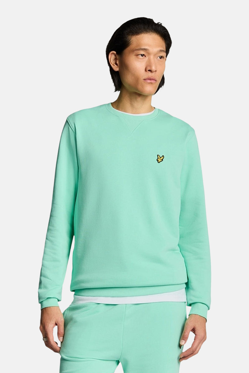 Sweat turquoise de LYLE & SCOTT, avec un petit logo jaune sur la poitrine et un col rond.
