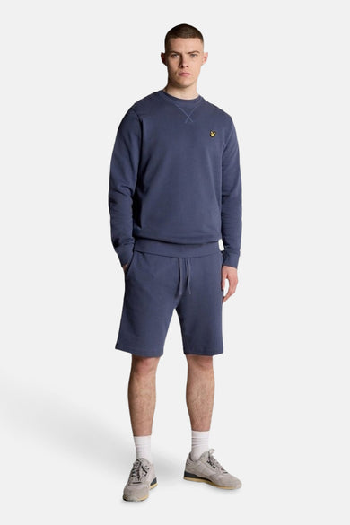 Sweat-shirt bleu chiné de LYLE & SCOTT, avec un petit logo jaune sur la poitrine et un col rond.