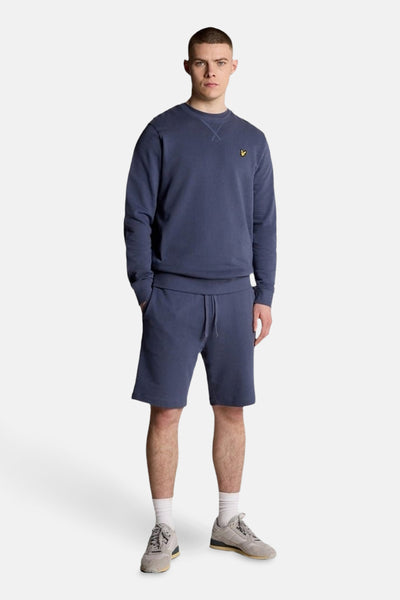 Sweat-shirt bleu chiné de LYLE & SCOTT, avec un petit logo jaune sur la poitrine et un col rond.