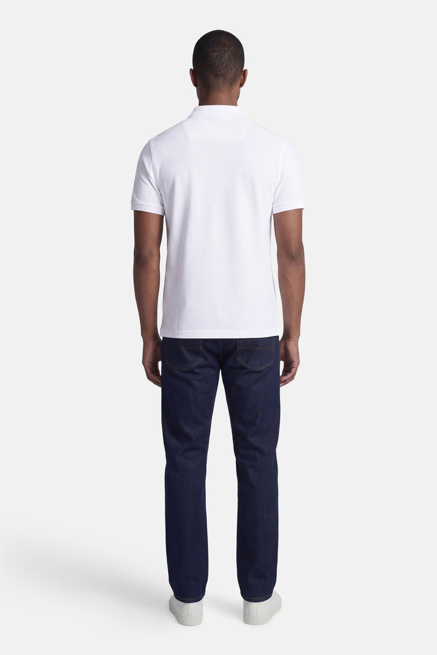 Wit BARBOUR poloshirt, achterzicht op paspop met donkere jeans.