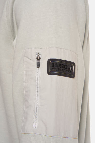 Sweat vert chiné par BARBOUR, avec une poche zippée et logo sur la manche.