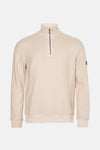 Beige trui met opstaande kraag van BARBOUR International met zichtbare ritssluiting aan de voorkant.