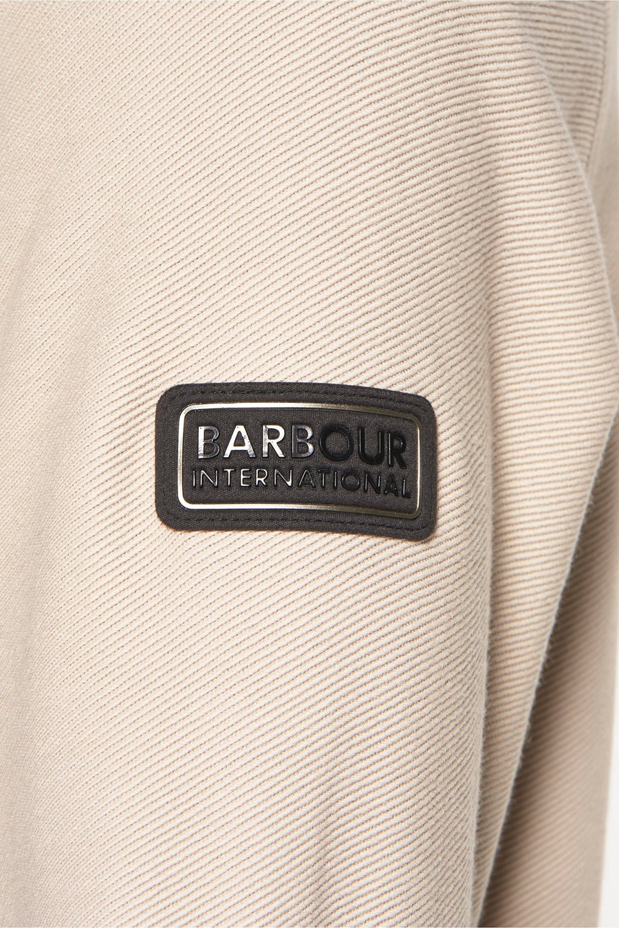 Beige sweater met opstaande kraag van Barbour International, met een geribbelde textuur.