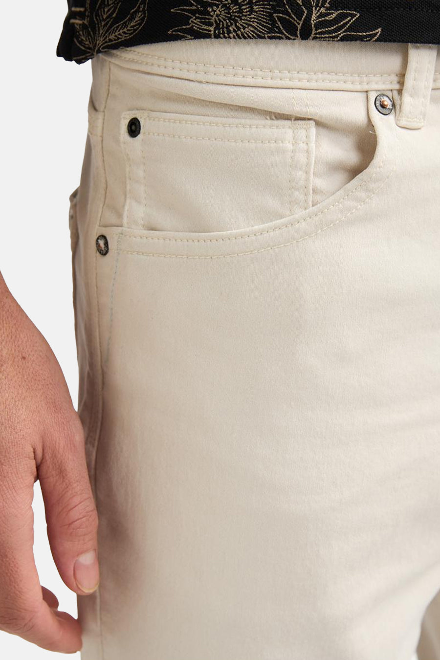 Short écru de Petrol Industries avec poche ticket et rivets, visible sur le côté droit, porté par un homme.