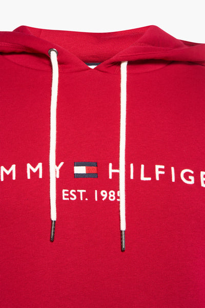 Red hooded sweatshirt by Tommy Hilfiger with white drawstrings and embroidered logo, front view close-up