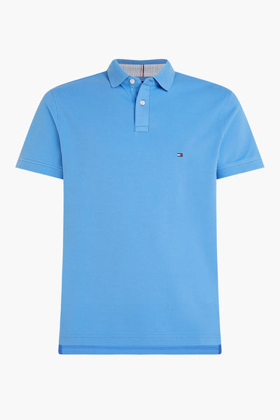 Polo bleu de TOMMY HILFIGER, avec col rayé et logo sur la poitrine, sur fond blanc.