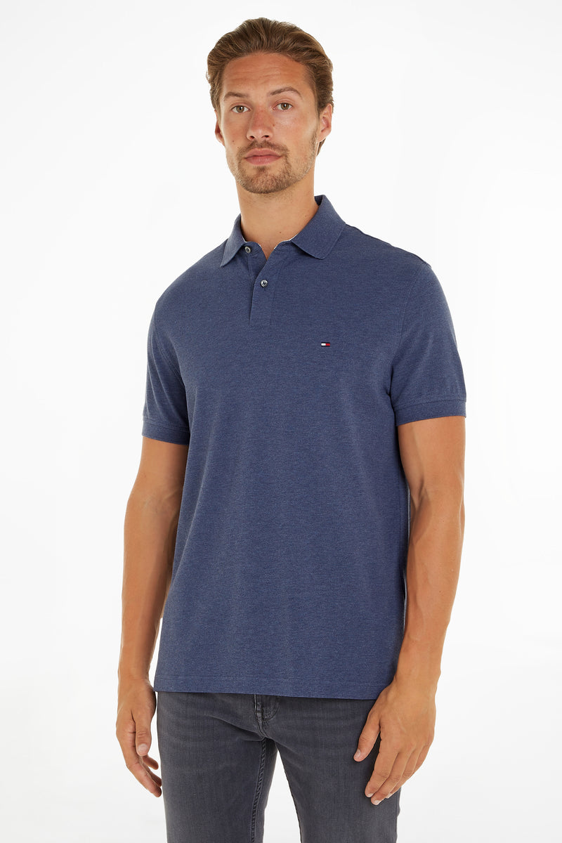Blue textured polo shirt by Tommy Hilfiger with small logo on chest, worn by model in front view