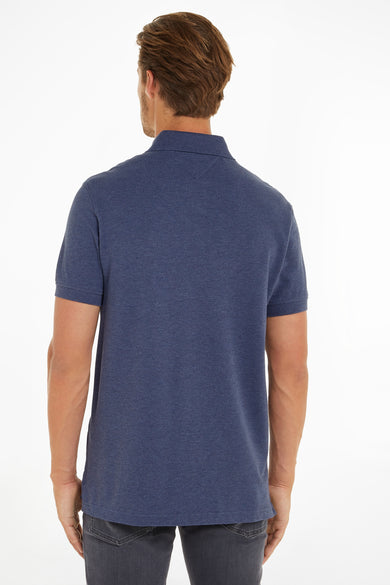 Blue polo shirt with ribbed collar and short sleeves, back view, worn with dark jeans
