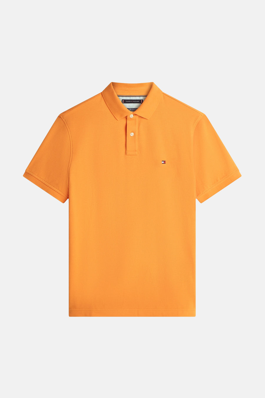 Polo à manches courtes orange de TOMMY HILFIGER, avec un logo discret sur la poitrine.