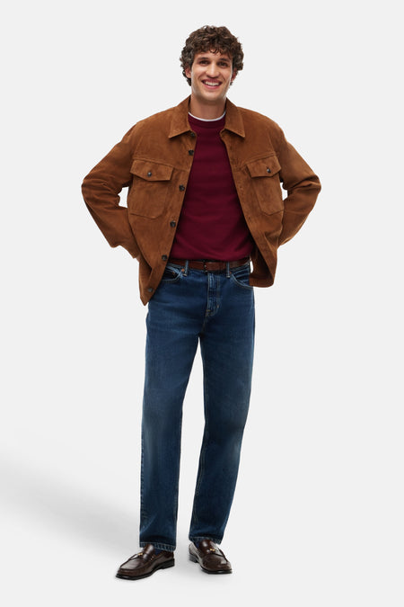 Red crewneck sweater worn under brown corduroy jacket, paired with dark blue jeans and brown loafers, full-body lifestyle view