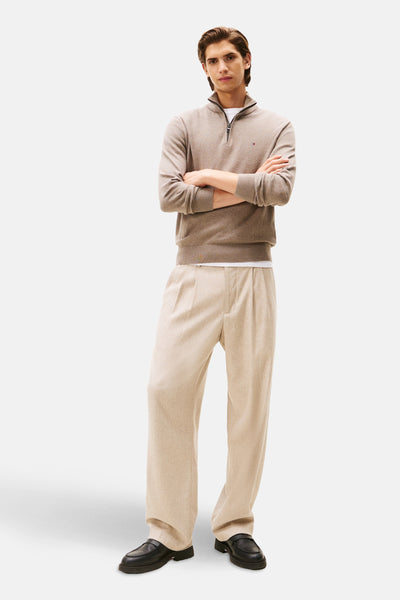 Beige coltrui van TOMMY HILFIGER, gedragen over een wit T-shirt, met een beige broek.