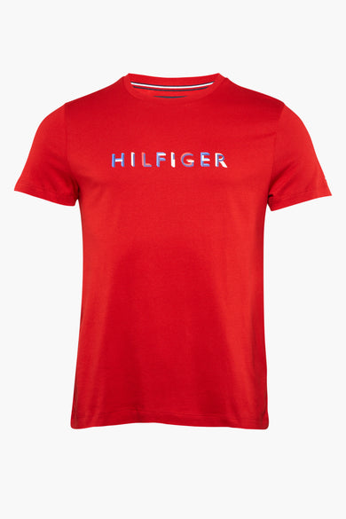 Red short-sleeve T-shirt by Tommy Hilfiger with embroidered multicolor logo across chest, ribbed crew neck with striped trim, front view.
