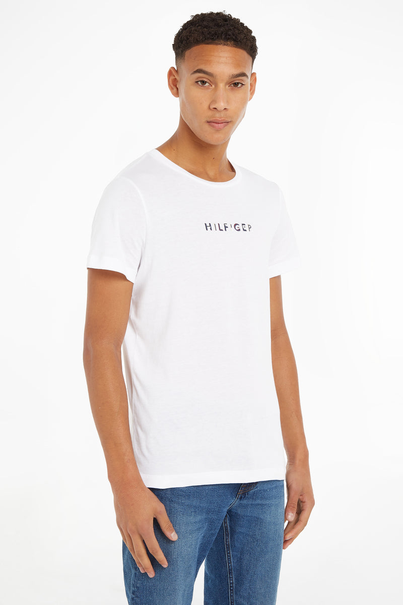 White short-sleeve T-shirt by Hilfiger with small chest logo, worn with blue jeans, front view