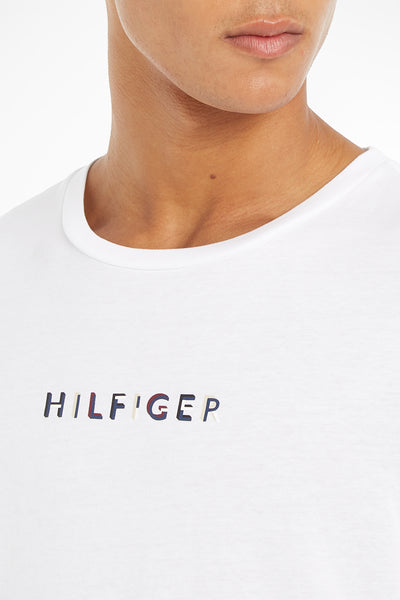 White short-sleeve T-shirt by Tommy Hilfiger with embroidered multicolor logo on chest, crew neck, close-up front view