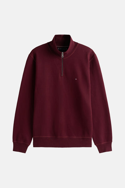 Bordeaux trui met opstaande kraag van Tommy Hilfiger met ritssluiting en discreet logo.