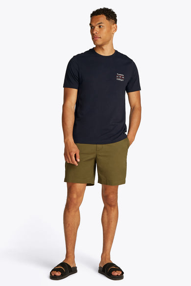 Marineblauwe T-shirt met korte mouwen van Tommy Hilfiger met discreet logo op de borst, gedragen met een olijfgroene korte broek.