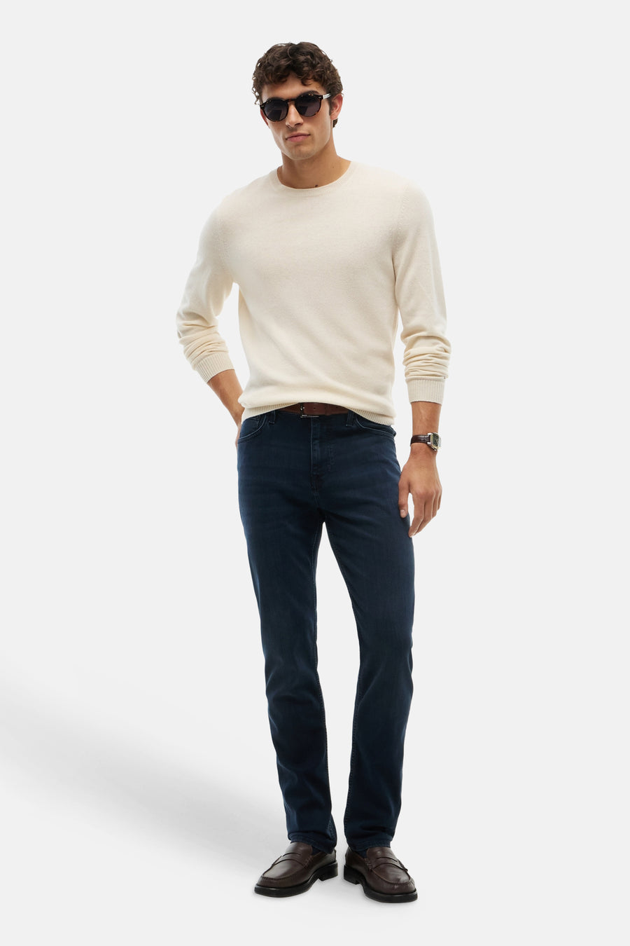 Blue black straight-leg denim jeans by DENTON, worn with cream sweater and brown loafers, full-length front view